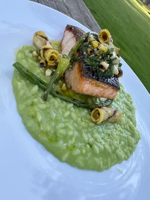 Pan-seared salmon with risotto prepared by the lodge chef